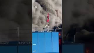 Crane operator lifts a man to safety from a burning highrise building in England  ABC News [upl. by Valida]